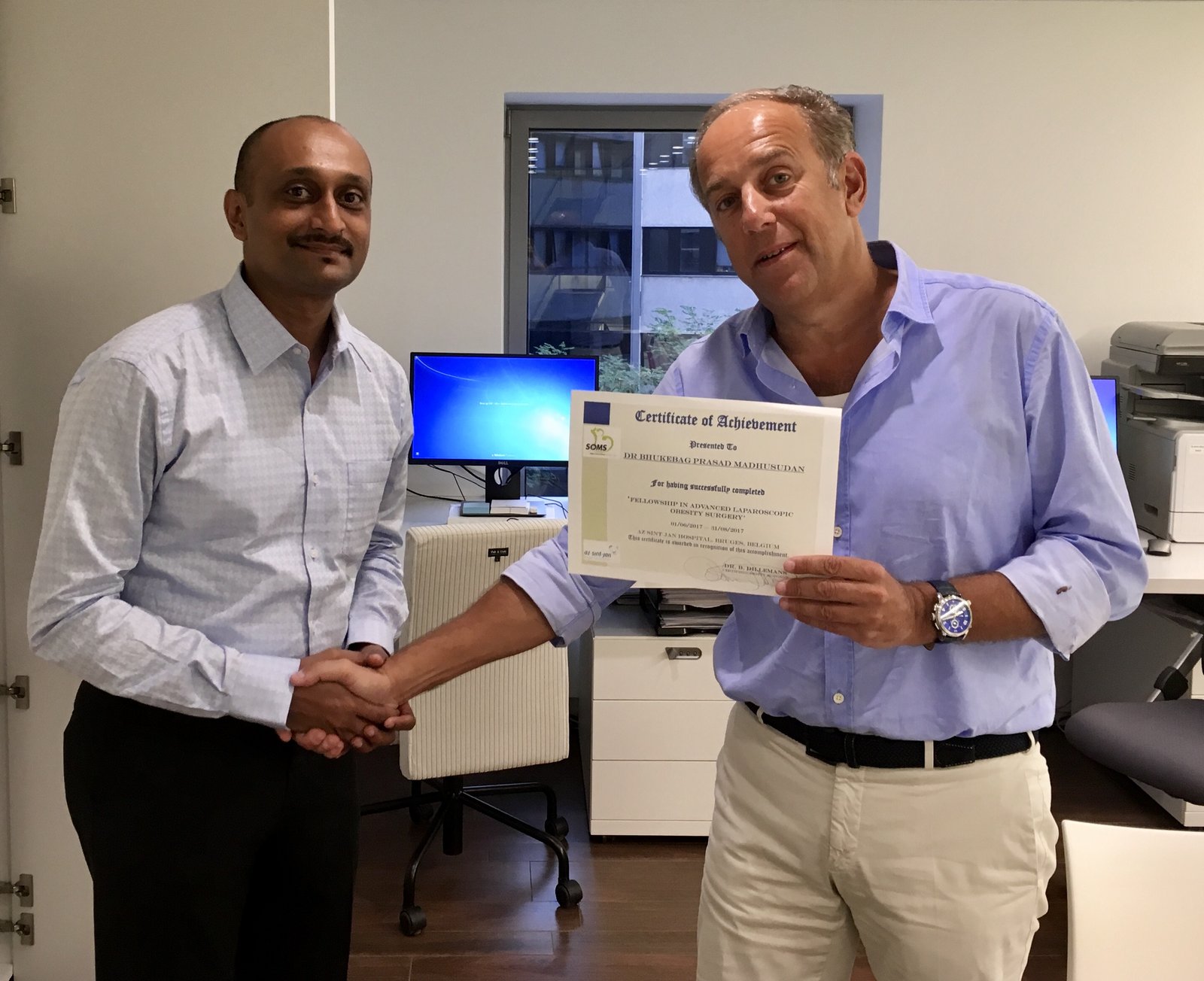 Dr Prasad Bhukebag receiving Fellowship certificate from Prof Bruno Dillemans in Bruges, Belgium