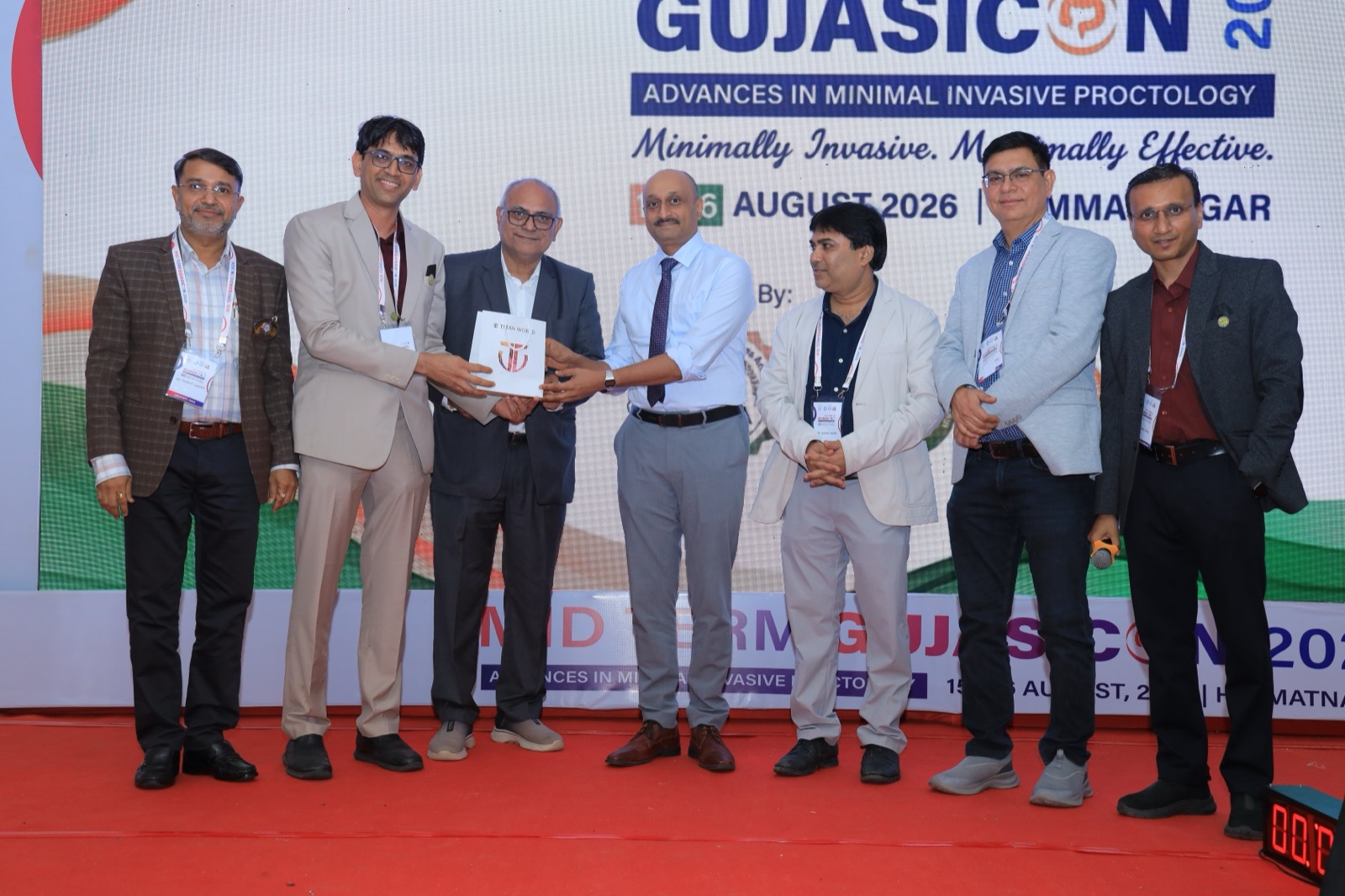 Dr Prasad Bhukebag receiving academic felicitation memento on stage at GujASICON 2026