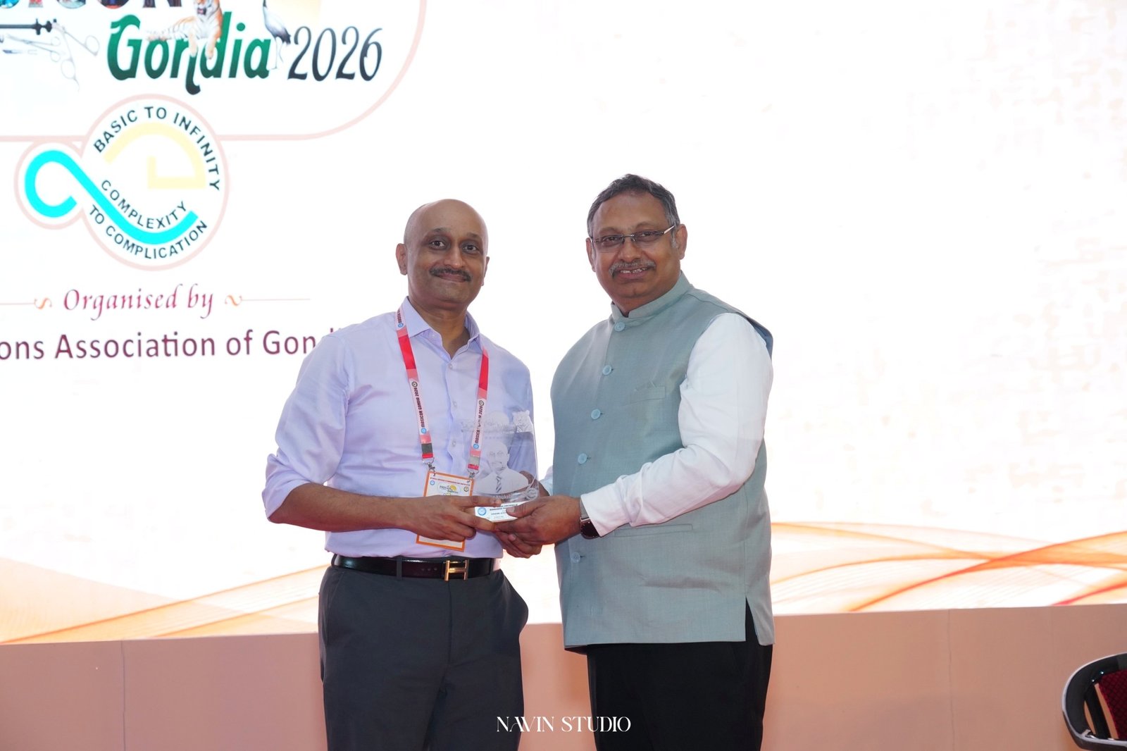 Dr Prasad Bhukebag receiving academic felicitation on stage at MASICON Gondia